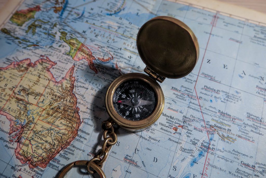 metal compass on world map for the manzanilla sophia blog
