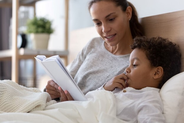 Image: Mom Reading Child Story in Bed