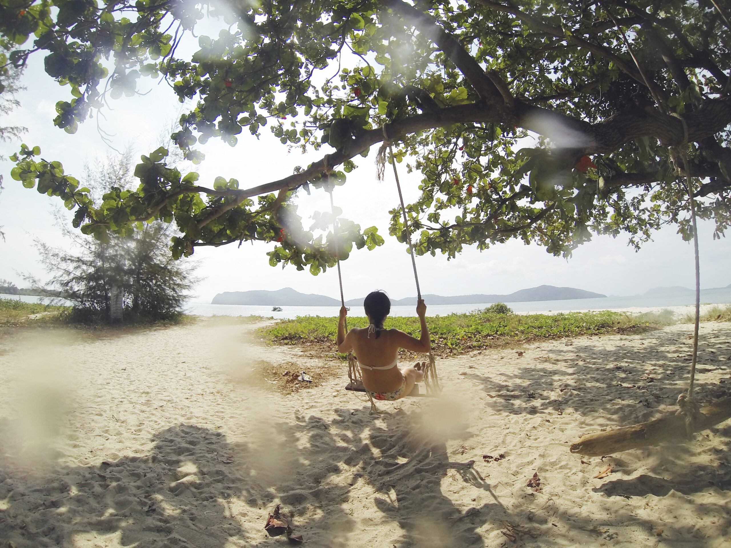 girl swinging on beach for the manzanilla sophia blog