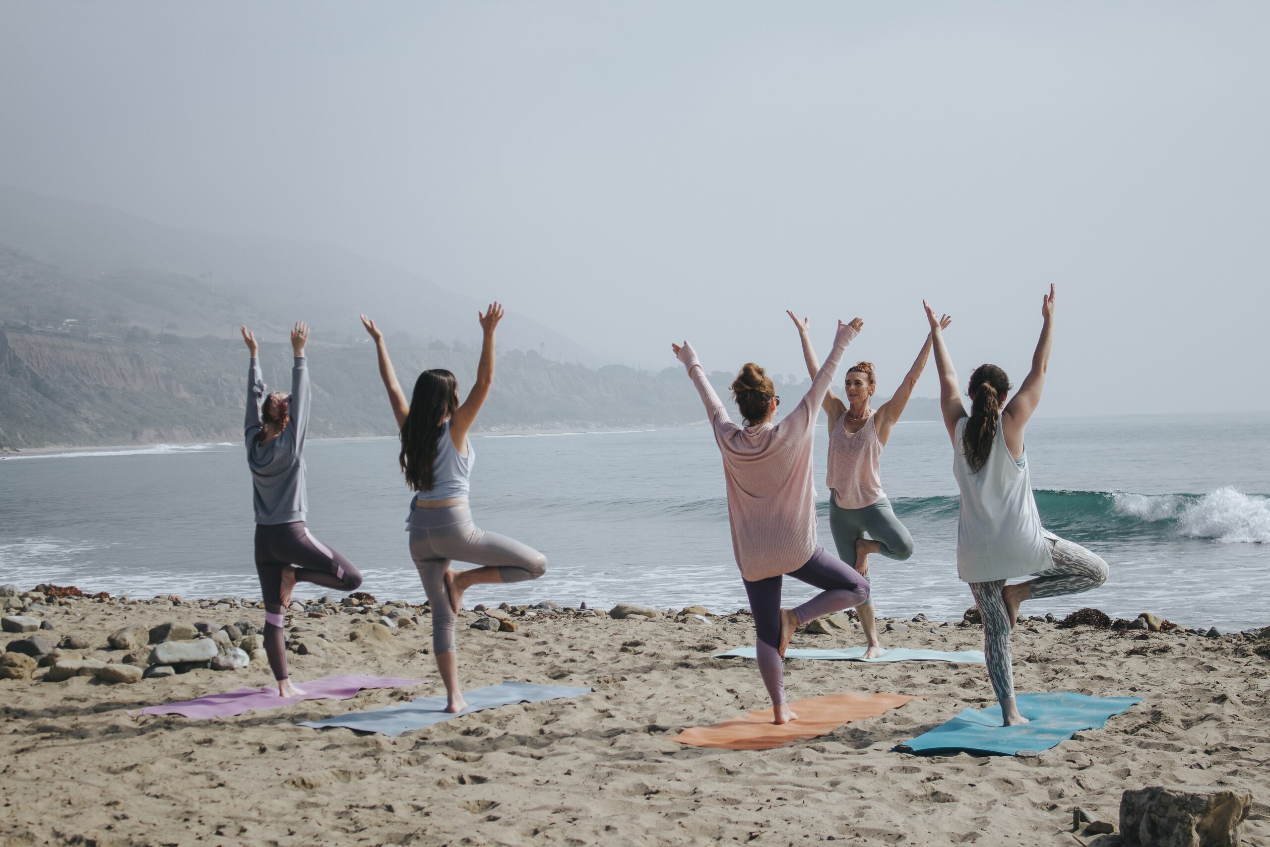 group yoga class on beach for the manzanilla sophia blog