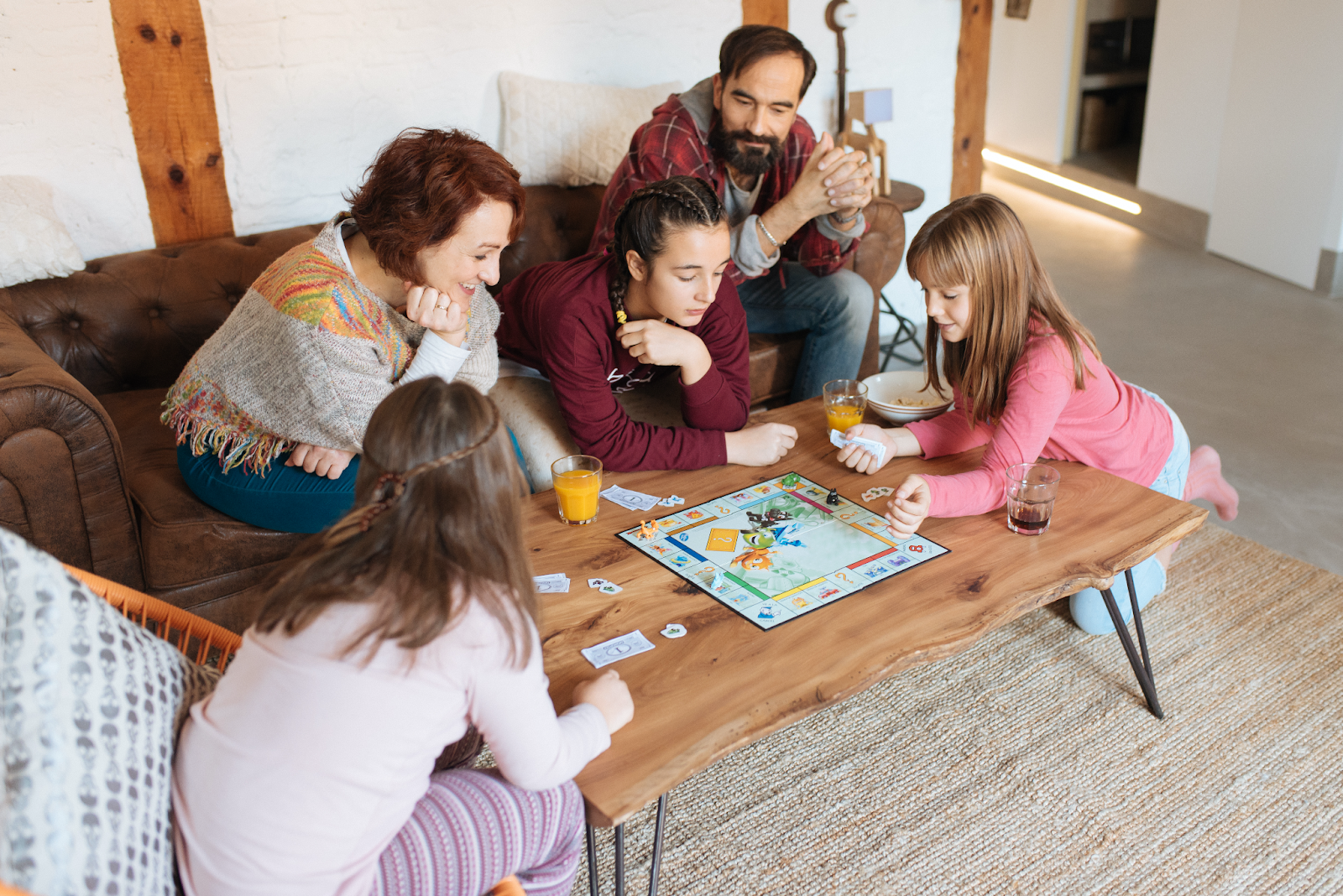 A family playing a board game together for the manzanilla sophia blog