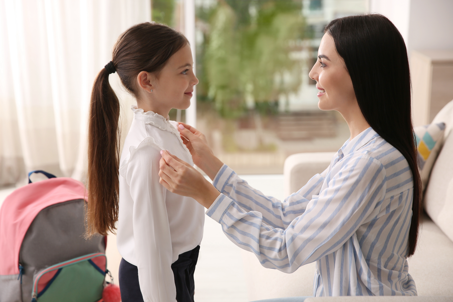 A mother helping her daughter get ready for school for the manzanilla sophia homeopathic remedies blog