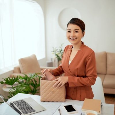 woman packing her bag at desk for the manzanilla sophia blog